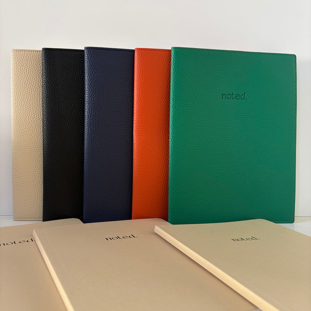 Set of five notebooks in different colors with 'noted' branding on a white background